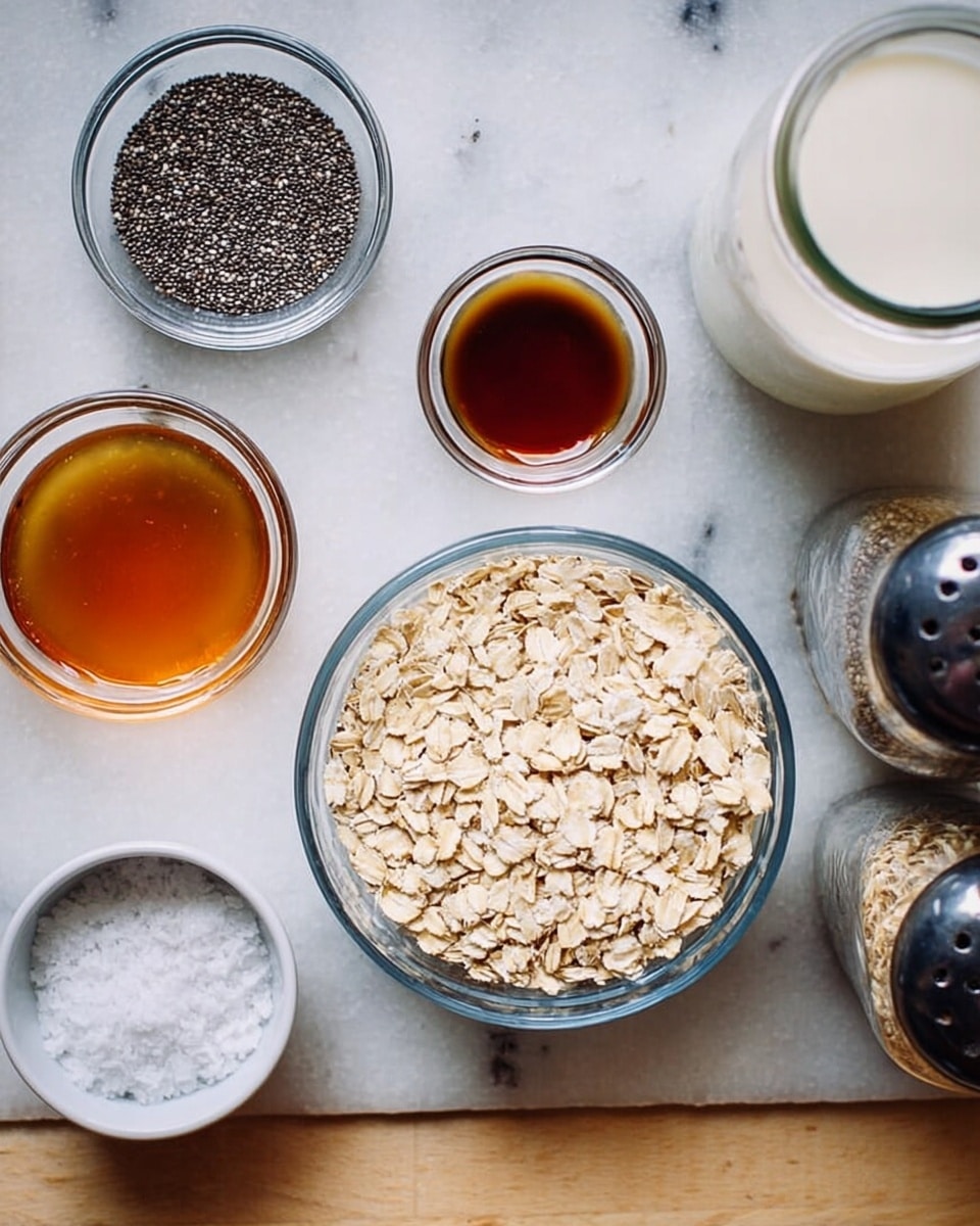 The image shows seven small white bowls and jars placed on a white marbled surface. One clear glass bowl in the center holds a single layer of light beige rolled oats with a dry, rough texture. Around it are smaller clear glass bowls; one contains tiny black chia seeds with a smooth, round texture, another has dark amber liquid, and a third holds a similar dark brown liquid but in a smaller quantity. There is also a small white bowl filled with coarse white salt crystals, showing a rough and uneven texture. A jar filled with white milk and two spice shakers with dark tops are also visible on the right side of the image. photo taken with an iphone --ar 4:5 --v 7