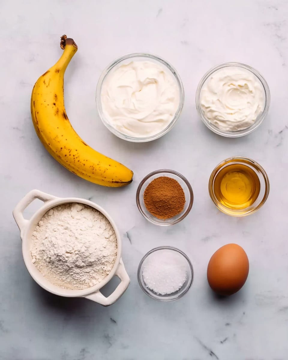 The image shows eight baking ingredients arranged on a white marbled surface. From left to right, there is a whole yellow banana with some brown spots. To the right of the banana, there is a white bowl filled with white flour, with two handles on the side. Above the flour bowl, there is a small clear glass bowl with white sour cream or yogurt inside. Next to the sour cream, there is a smaller clear glass bowl with white baking powder or similar powder. Below the flour bowl, there is a small glass bowl with white granulated sugar. Next to the sugar bowl is a slightly bigger glass bowl with golden honey or syrup. Above the honey is a small clear bowl filled with brown cinnamon powder. Finally, on the far right, there is a single brown egg. All items are neatly spaced with no overlap. Photo taken with an iphone --ar 4:5 --v 7