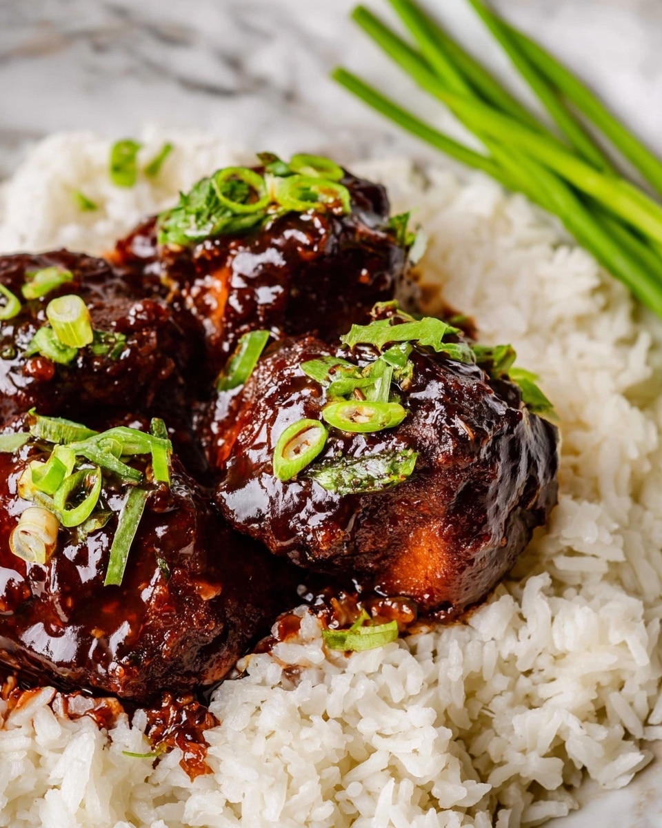 The dish shows three pieces of cooked meat with a dark brown glossy sauce covering the top, sprinkled with small pieces of green onions. The meat sits on a base of white cooked rice, which looks soft and fluffy, filling the space around the meat. In the background, near the top right, there is a small bunch of green sliced scallions. The whole meal is on a surface with a white marbled texture. photo taken with an iphone --ar 4:5 --v 7