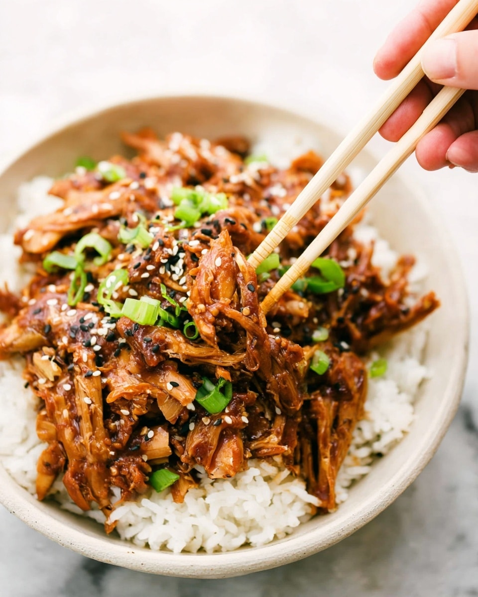 A bowl filled with two main layers is shown against a white marbled background, a woman's hand holding chopsticks picking up some food. The bottom layer is white rice with a fluffy texture, covering the base completely. On top, there is a thick layer of brown glazed shredded meat, mixed with small white and black sesame seeds and sprinkled with bright green sliced scallions. The bowl is white and curved, holding the food neatly, and the chopsticks are light beige, held by a woman's hand at the top right corner of the image. photo taken with an iphone --ar 4:5 --v 7