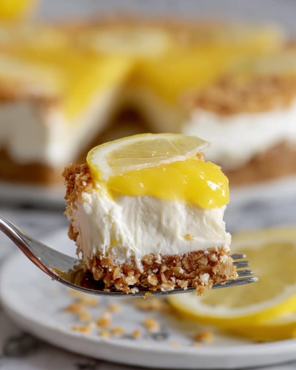 A close-up view of a fork holding a small piece of a dessert with three visible layers: the bottom layer is a crumbly oat and nut crust, the middle layer is thick and white, resembling whipped cream or a creamy filling, and the top layer is a shiny yellow lemon curd. In the background, the rest of the dessert sits on a white plate with a white marbled surface underneath it. The dessert on the plate has a thin slice of lemon and some sprinkled crumbs on top, showing the texture of the crust clearly. Photo taken with an iphone --ar 4:5 --v 7