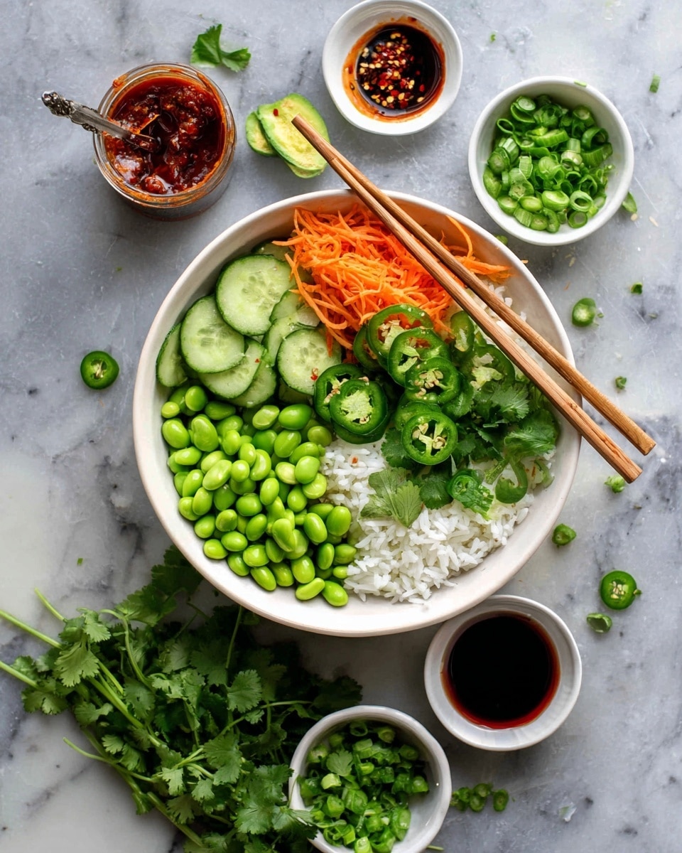 A white bowl with four layers of food inside sits on a white marbled surface. The first layer is soft, white rice filling most of the bowl. On top, the second layer is bright green sliced jalapenos on the right upper side, next to fresh cucumber slices with a light green color and dark green edges. Below the cucumbers is a cluster of smooth green edamame beans. To the left of the beans is thinly shredded bright orange carrots, and above the carrots, fresh green cilantro leaves add a leafy texture. Long wooden chopsticks rest on top of the bowl, crossing over the rice and vegetables. Surrounding the bowl are small white bowls holding more green edamame, dark green chopped scallions, green jalapeno slices, red chili sauce, and a dark sauce with chili flakes and a spoon inside. Bright green cilantro sprigs are spread loosely near the bottom left corner, enhancing the fresh look. Photo taken with an iphone --ar 4:5 --v 7