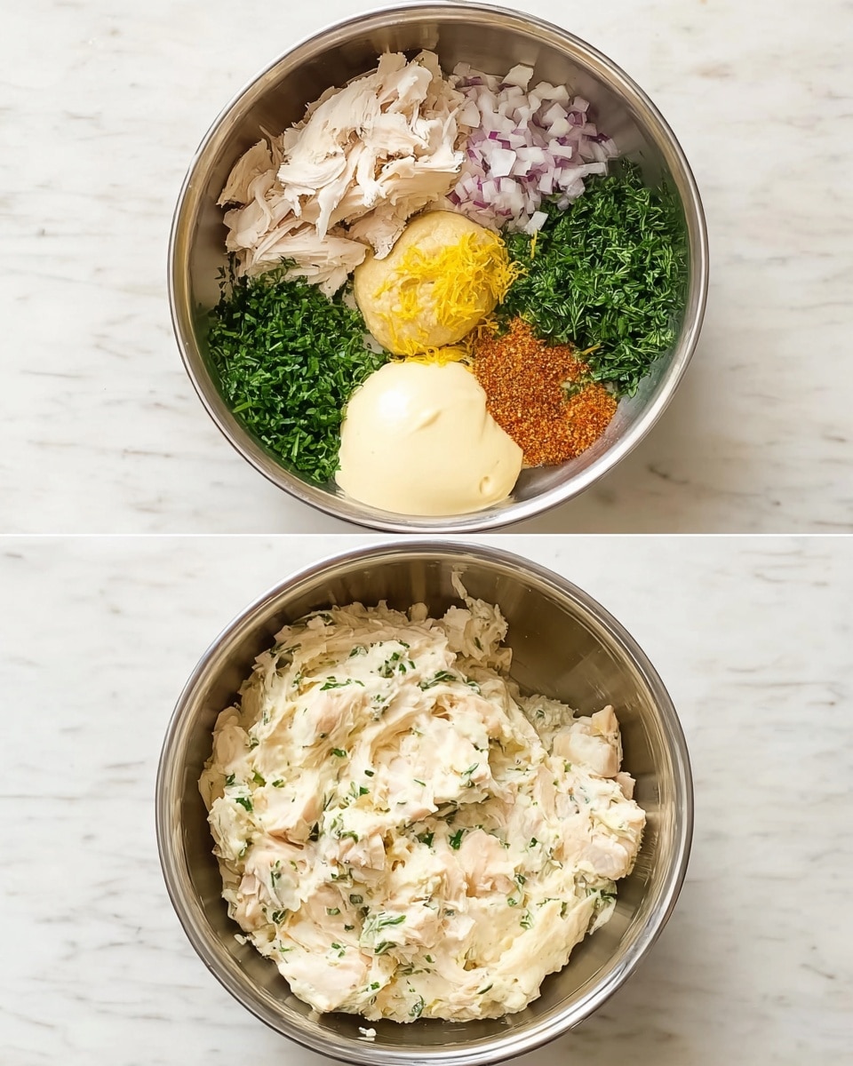The image shows two metal mixing bowls placed on a white marbled surface. The top bowl contains several distinct layers: to the left, there are white shredded pieces of cooked chicken, next to it is a pile of chopped green herbs, then finely chopped light purple shallots to the right, a large creamy white dollop of mayonnaise, a scoop of creamy yellow hummus near the bottom center, bright yellow lemon zest, and a small heap of reddish brown seasoning, with a sprinkle of black pepper blending into the layers. The bottom bowl shows the mix after stirring, a creamy off-white chicken salad with small green herb flecks evenly distributed throughout, with a somewhat chunky and smooth texture. Photo taken with an iphone --ar 4:5 --v 7