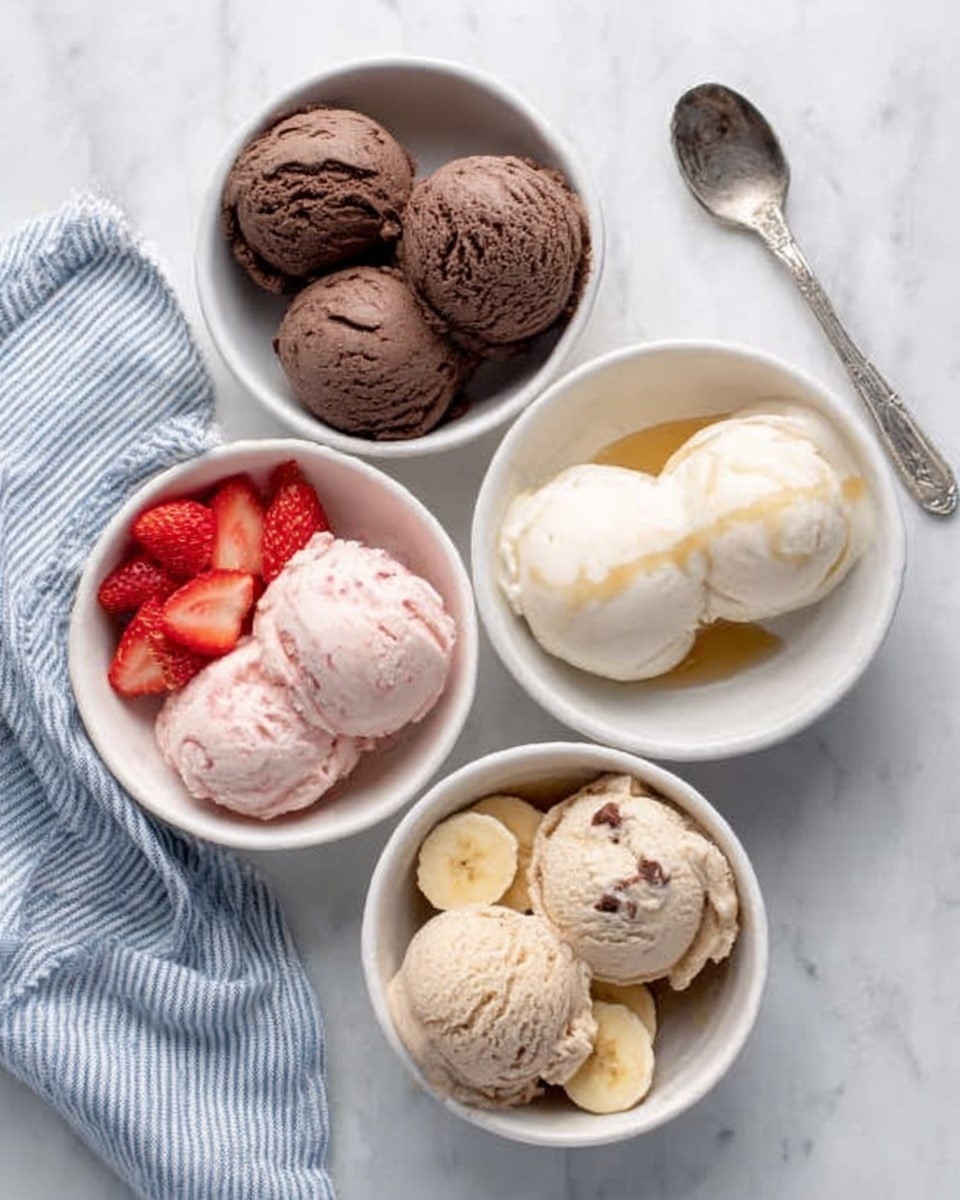 Four white bowls with different ice cream scoops are placed on a white marbled surface. The top right bowl holds two round scoops of pale white ice cream with light syrup drizzled on them. The top left bowl contains three scoops of dark chocolate ice cream with a smooth and creamy texture. The bottom right bowl has three scoops of light brown ice cream decorated with banana slices on top. The bottom left bowl shows three scoops of pink strawberry ice cream with three halved strawberries placed around the scoops. A silver spoon is near the top left bowl next to a blue and white striped cloth. Photo taken with an iphone --ar 4:5 --v 7