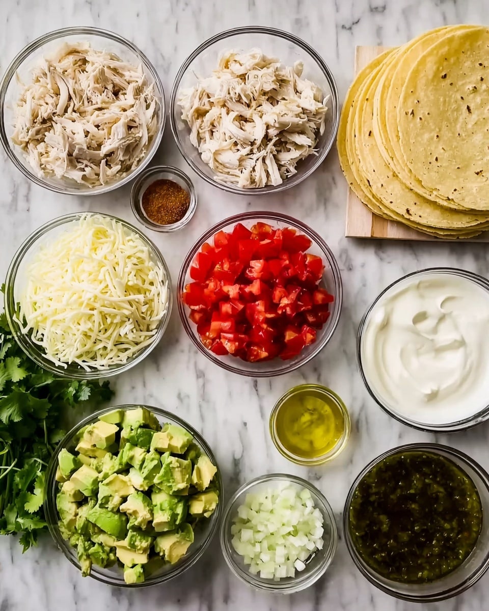 The image shows a variety of small clear glass bowls arranged on a white marbled surface, each filled with different taco ingredients. There are shredded light beige chicken pieces, bright red diced tomatoes, a small bowl of brown seasoning, and a stack of pale yellow corn tortillas to the upper right. Below these, there is a bowl filled with shredded white cheese, a bowl of smooth white sour cream, a small bowl of greenish oil, and a bowl of dark green salsa. At the bottom, there are chopped white onions, diced green avocado, and a small mound of minced pale yellow garlic. A sprig of fresh cilantro is placed to the left side. The colors of the ingredients create a fresh and vibrant display. photo taken with an iphone --ar 4:5 --v 7