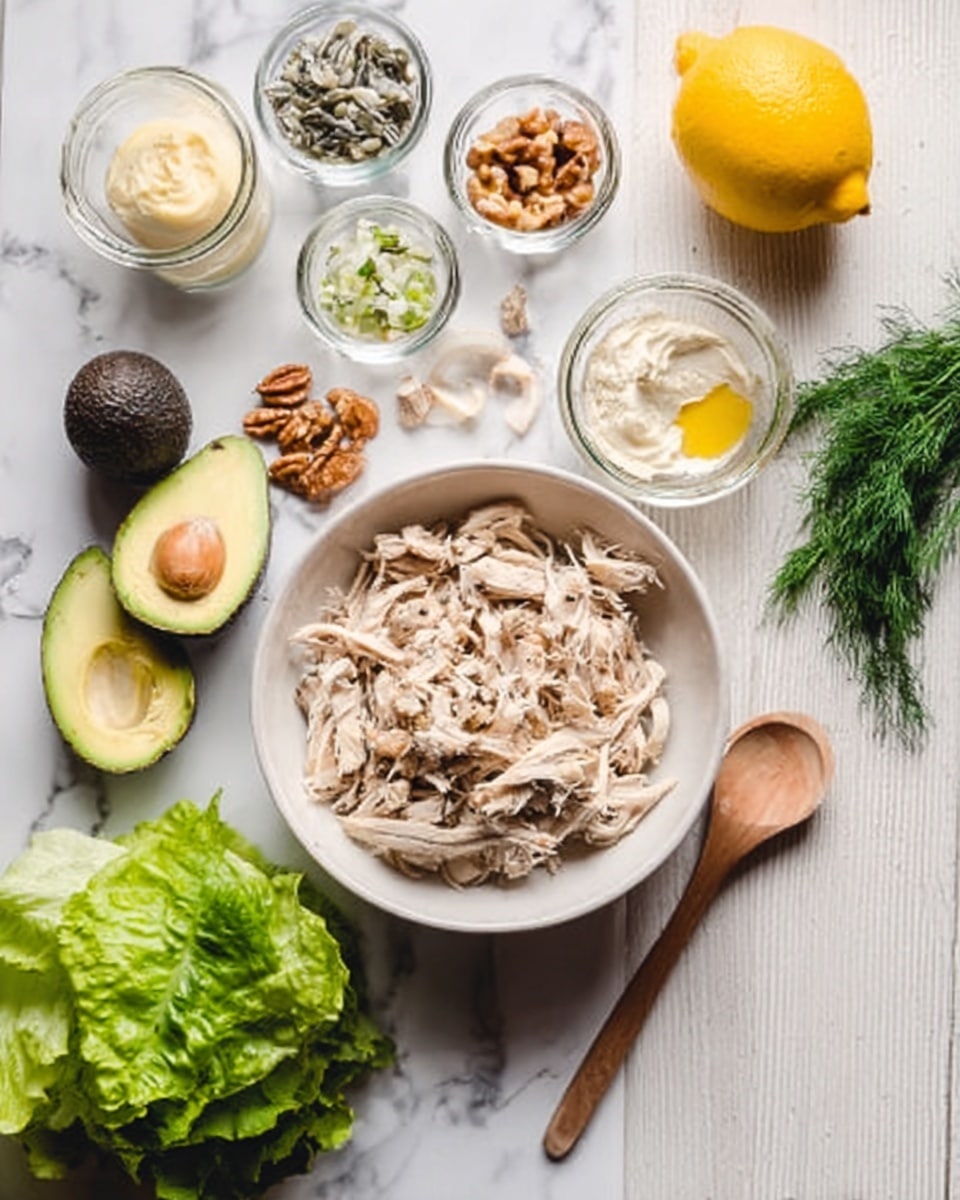 A white bowl on a white marbled surface holds several pieces of cooked, shredded light brown chicken. Surrounding the bowl are small glass bowls and jars containing various ingredients: chopped nuts, beige garlic cloves, light yellow mustard, creamy white substance, fresh green dill, dark green avocado, and fresh green lettuce leaves. There is a bright yellow lemon and a woman's hand holding a wooden spoon resting on the surface near the bowl. photo taken with an iphone --ar 4:5 --v 7