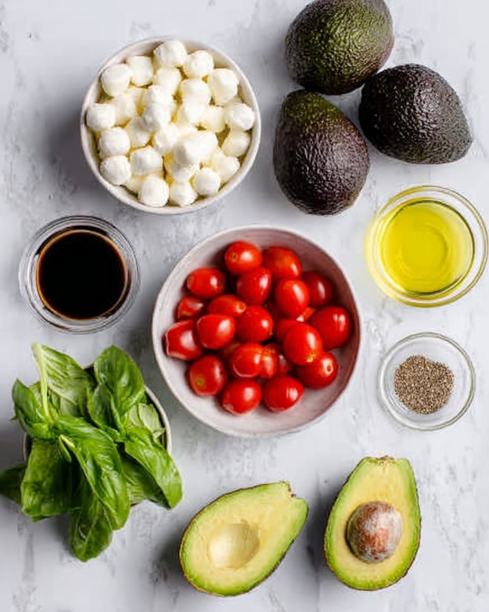 The image shows a white marbled surface with a white bowl filled with small white cheese balls in the bottom left. Above it, there is a white bowl full of halved small red cherry tomatoes. To the right of the tomatoes is a white bowl with dark brown balsamic vinegar. Below the vinegar is a bunch of bright green basil leaves. On the top left side, there are three whole dark green avocados, and to their right, a small clear bowl with light yellow olive oil. Below the oil, a small dish with brown pepper. One avocado is sliced in half showing its green inside and large brown seed. photo taken with an iphone --ar 4:5 --v 7