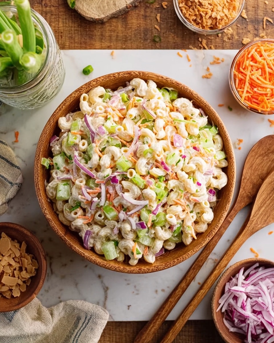 A wooden bowl filled with macaroni salad sits in the center, showing about three layers: the bottom layer has creamy white macaroni pasta, the middle layer includes light green celery slices and finely chopped red onion pieces, and the top layer features small bits of shredded carrot and green onion, all mixed together. Around the bowl, there are wooden salad utensils to the right and various small bowls filled with shredded carrot, chopped red onion, and brown sugar, all resting on a white marbled surface. A woman's hand is holding a clear jar near the top left, adding a natural touch. The overall look is fresh, colorful, and textured. photo taken with an iphone --ar 4:5 --v 7