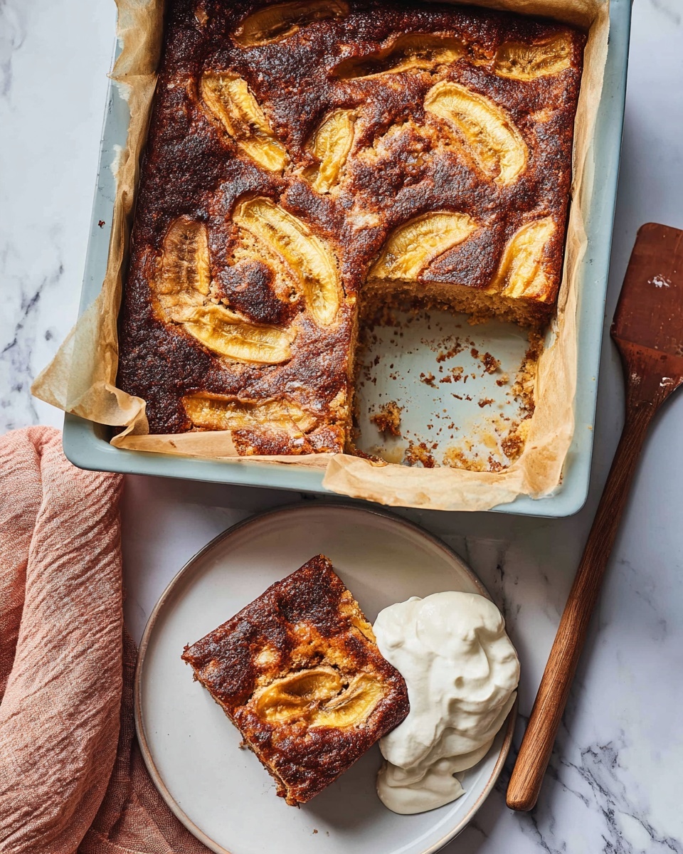 The image shows a baked dish in a rectangular light blue baking dish lined with parchment paper, with one large piece missing. The baked surface is dark golden brown with swirled lighter patches, showing thin slices of fruit embedded in the top layer. Next to the baking dish on a white plate is a single square piece of the same baked dish, showing a moist inside with visible light yellow fruit slices throughout. Beside the slice on the plate is a dollop of white whipped cream. A wooden spatula with crumbs rests on the white marbled surface nearby, and a woman's hand is partly visible holding the plate from the left edge of the image. The background is a white marbled texture. photo taken with an iphone --ar 4:5 --v 7