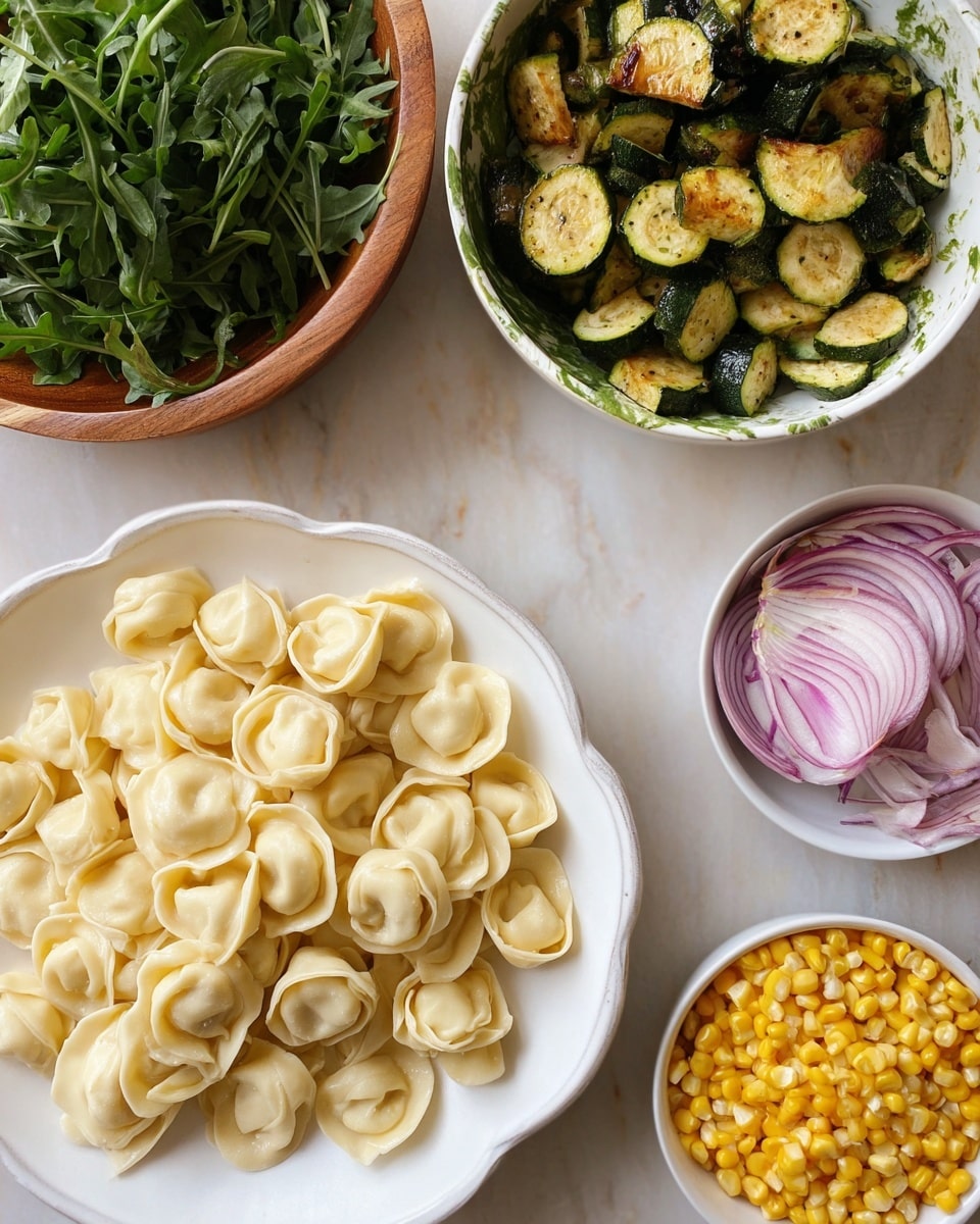 The image shows a white wavy-edged plate filled with many pieces of fresh tortellini pasta, pale yellow in color and soft in texture, positioned in the lower center. Above it, there is a white bowl with green splotches, filled with cooked zucchini pieces that are green and golden brown with a slightly shiny, tender look. To the left, a wooden bowl holds fresh green arugula leaves that look crisp and vibrant. On the right side, two small white bowls hold yellow corn kernels and thinly sliced red onions with purple and pale pink layers, both fresh and bright. The background is a white marbled surface. Photo taken with an iphone --ar 4:5 --v 7