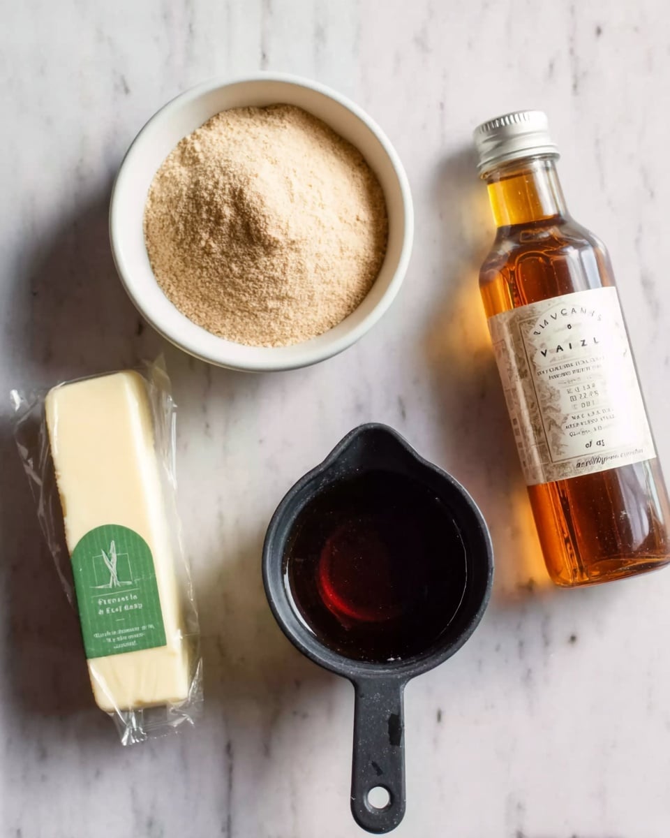 The image shows four baking ingredients on a white marbled surface. At the top left is a white bowl filled with light brown powder, next to it at the top right is a bottle of vanilla extract with a light brown liquid inside. Below the bowl and bottle, there is a black measuring cup with a dark brown thick liquid inside, labeled 1/4. To the left of the measuring cup is a stick of cream-colored butter, wrapped in paper with green labeling. Photo taken with an iphone --ar 4:5 --v 7
