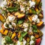 Grilled Peach Salad with Burrata, Basil Pesto Croutons, and Toasted Pine Nuts Recipe