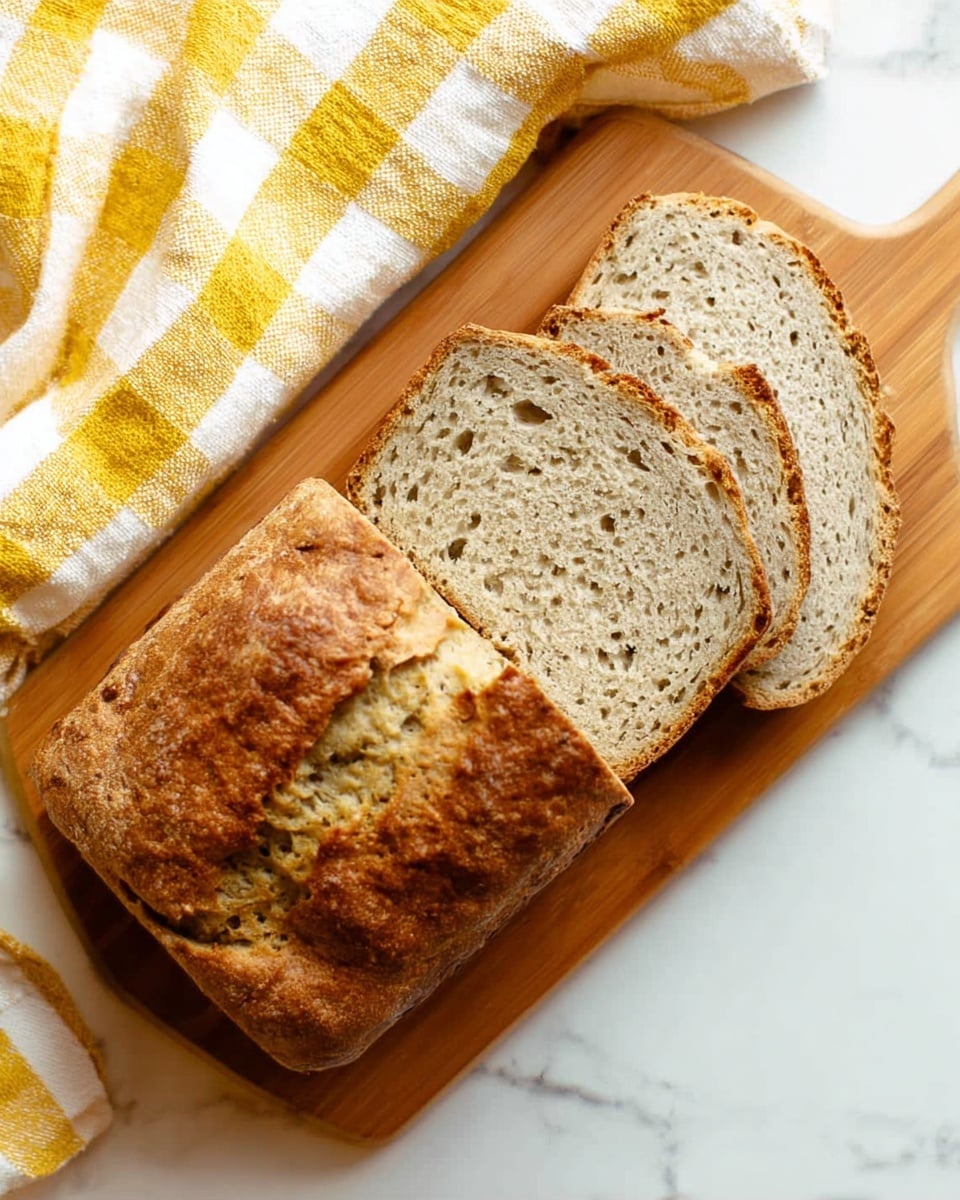 Four slices of banana bread are stacked slightly leaning against each other on a white plate. Each slice shows a brown crust with a rough, textured surface and a soft inside that has small banana and nut bits visible throughout. The bread color inside is a light brown with darker spots from the ingredients. The plate rests on a white marbled surface. photo taken with an iphone --ar 4:5 --v 7
