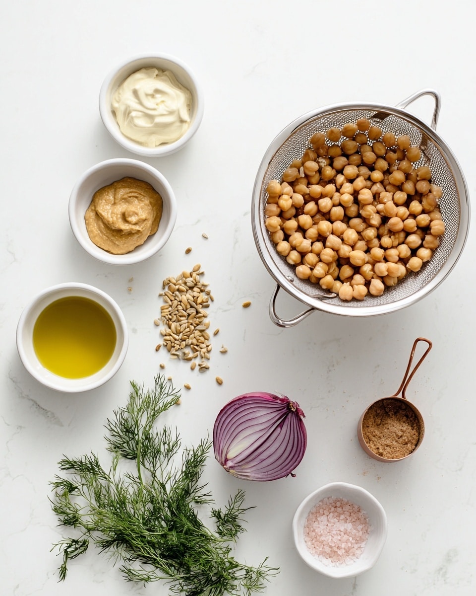 The image shows a white colander filled with light brown chickpeas on the right side, sitting on a white marbled surface. To the left, three small white bowls form a vertical line— the top bowl holds a creamy white sauce, the middle bowl contains a smooth mustard-colored paste, and the bottom bowl is filled with small toasted seeds. Below these, there is some fresh green dill with thin leaves lying next to a small white bowl filled with golden liquid. A purple half of an onion sits nearby, showing its layered texture. At the bottom right, there is a small white container with pink salt and a copper measuring spoon resting inside. The overall layout is clean and simple with a focus on the natural colors and textures of the ingredients, photo taken with an iphone --ar 4:5 --v 7
