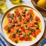 Salmon Crudo with Tomato-Lemon Dressing and Mediterranean Garnishes Recipe