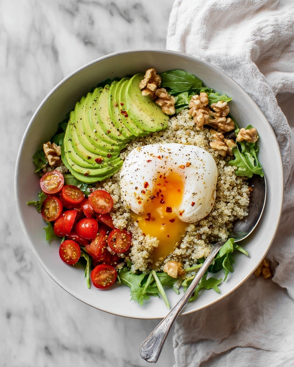 A white bowl filled with a bed of green leafy lettuce at the bottom, topped with a layer of light beige couscous sprinkled with crushed nuts. On one side of the bowl, there are slices of pale green avocado, and on the other, bright red cherry tomatoes cut in halves. In the center, there is a soft poached egg with white edges and its yellow yolk slightly spilling out. A silver spoon rests inside the bowl. The background is a white marbled surface. Photo taken with an iphone --ar 4:5 --v 7